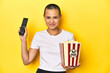 © Asier - Woman with popcorn and TV remote, home cinema concept