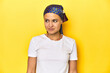 © Asier - Young woman with headscarf, cancer support concept, studio backdrop