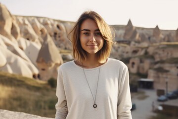 Wall Mural - Close-up portrait photography of a glad girl in her 20s wearing a simple cotton shirt at the cappadocia in nevsehir province turkey. With generative AI technology