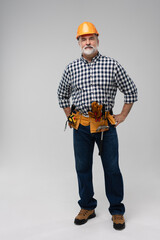 Wall Mural - full lenght of mature happy handyman isolated on white background.