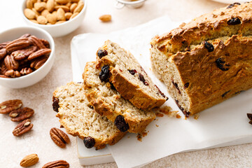 Wall Mural - Fruitcake with cranberry, almond and pecan nuts sliced on a wooden board