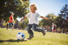 Young Soccer Player Having Fun On A Field With Ball