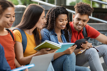 Wall Mural - Diverse Multiethnic Students Reading Books And Using Digital Tablet Outdoors