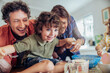 © Marko Geber - Young caucasian family being messy and having fun baking together in the kitchen