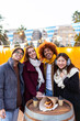 © Xavier Lorenzo - Smiling portrait of young group of student friends enjoying time together on winter. Young adult people having fun during christmas vacation outdoors.