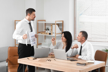 Wall Mural - Business consultants working at table in office