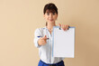 © Pixel-Shot - Beautiful businesswoman with clipboard on beige background