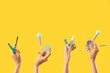 © Pixel-Shot - Women with makeup products on yellow background