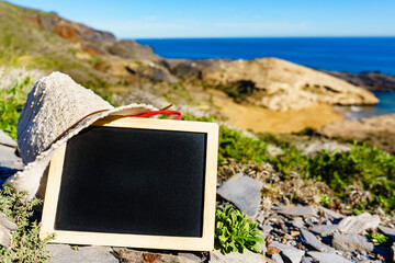 Wall Mural - Blank black board against sea coast