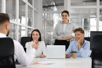 Sticker - Colleagues working together in open plan office