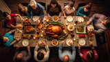 Fototapeta Uliczki - a family gathered at a festive table, with a large turkey in the center