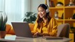 © AI Images - Generative AI : young woman in yellow sweater using laptop for work on design project at home