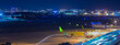 airport runway night scene with city skyline in the background