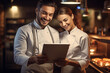© toonsteb - male chef holding a tablet to welcome customers
