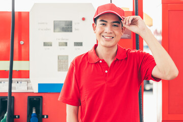 Wall Mural - Portrait Gas station service staff Asian male worker happy smiling working car gasoline refill service job.