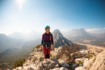 Wall Mural - hiking in the mountains. a girl with a backpack walks along a mountain range. climbing and hiking.