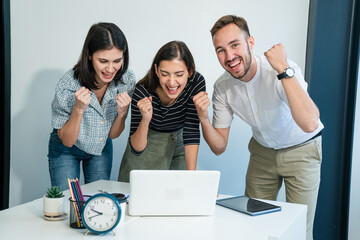 Wall Mural - Happy diverse friends watching funny video, laughing at joke, using laptop and having fun together, brainstorm together at meeting	