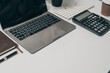 © R Photography - Office desk essentials top view of business objects including laptop, calculator, notebook, and pen organized workspace for success, Mock up, nobody