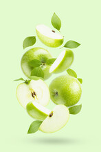 Juicy Green Apples With Green Leaves Fly As Flow On Light Green Background, Closeup, Whole, Half And Quarter Fruit, Isolated, Shadow. Summer Fruits For Advertising, Design, Label Product.