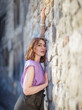 © Igor Borodin - Beautiful successful middle aged woman posing against a stone wall street, photo shoot
