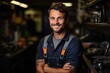 © evannovostro - Portrait of a plumber. Smiling adult european man stands with crossing hands in a workshop
