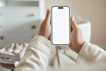 pregnant woman showing blank smartphone screen while resting on couch at home. expectant mom holding