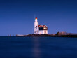 A lighthouse on the beach during blue hour. A landmark in maritime navigation. Long exposure. Natural composition. Photo for wallpaper and background. Paard van Marken, Netherlands.