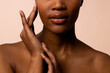 © wavebreak3 - Crop of african american woman with short hair touching hands and face