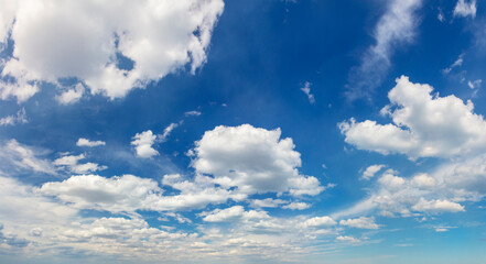 Wall Mural - Panoramic sky - real blue sky during daytime with white light clouds Freedom and peace. Large photo format Cloudscape blue sky.