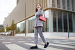 © Prostock-studio - Successful Young Businesswoman Communicating Talking By Cell Phone Walking Outside