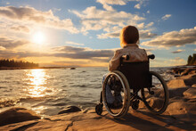 girl with disabilities in a wheelchair on the river bank admires nature. copy space for text
