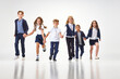 © master1305 - Group of stylish children, boys and girls, pupils in school uniform running against white studio background. Classmates. Concept of childhood, school, education, fashion, style. Copy space for ad