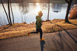 © baranq - Picture of man running in park during sunny autumn afternoon