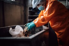 Shot Of An Unrecognizable Person Disposing Of Waste In A Recycling Plant