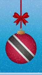 Wall Mural - Snow falling on christmas ball with flag of Trinidad and Tobago