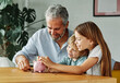 © Lumos sp - child money saving grandfather family coin senior grandchild bank piggybank  finance happy investment grandson granddaughter