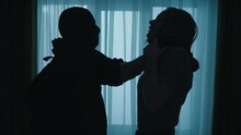 Defenceless And In Danger. A Robber In A Black Balaclava Holds A Frightened Woman By The Neck, Strangling Her Close Up.