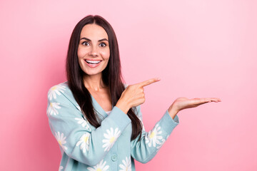 Sticker - Photo of overjoyed impressed woman dressed blue cardigan directing at palm show proposition empty space isolated on pink color background