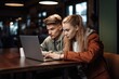 © Alfazet Chronicles - shot of two young people using a laptop together in a coffee shop