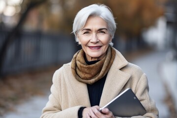 Poster - portrait of a mature woman holding a digital tablet