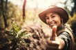 © altitudevisual - shot of a unrecognizable young woman giving the thumbs up while working in nature