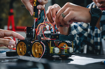 Engineer Asian Students Assembling Robotics Kits. Learning Mechanical Control, Robotics combines computer, electrical, mechanical, and sensing. Empowering Engineers and Development Concept.