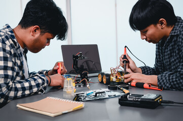 Engineer Asian Students Assembling Robotics Kits. Learning Mechanical Control, Robotics combines computer, electrical, mechanical, and sensing. Empowering Engineers and Development Concept.