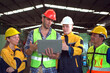 © DG PhotoStock - Professional male and female industrial engineers or technicians walking in the abandoned factory to inspect the machines and construction. Team of engineer have a discussion in factory.
