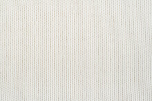 Sweater Or Scarf Fabric Texture Large Knitting. Knitted Jersey Background With A Relief Pattern. Wool Hand- Machine, Handmade.