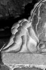 Sticker - A detail of an ancient statue in black and white film negative.