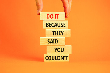You can do it symbol. Concept words Do it because they said you could not on wooden block. Beautiful orange table background. Businessman hand. Business, motivational you can do it concept. Copy space