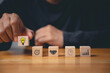 © sorapop - Business success and support through consulting. Wood block with glowing light bulb icon on hand against. New initiative and strategy brainstorm for digital transformation. Creative inspiration