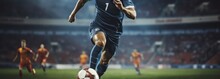 Soccer Player In Action On The Field Of Stadium. Blurred Background. Football Concept With A Copy Space. Soccer Concept With A Space For A Text.