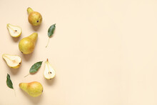 Ripe Pears And Leaves On Yellow Background